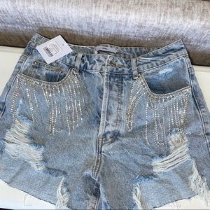 Denim shorts with diamond tassels.